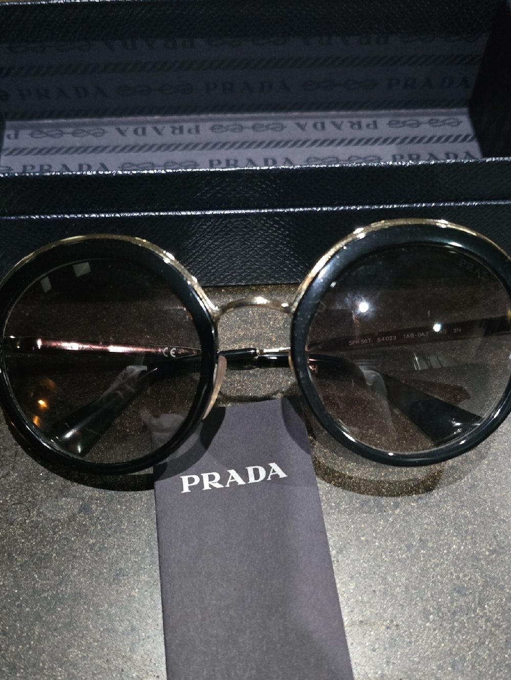 Prada Round Sunglasses in Black and Gold